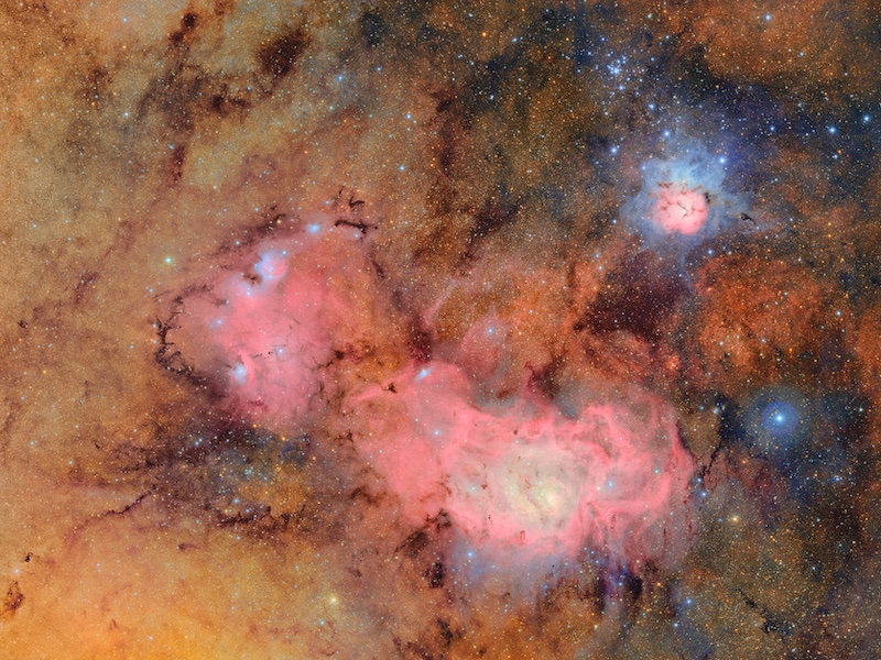 Combined images showing clouds of gas and dust that comprise the Trifid nebula and the Lagoon nebula.